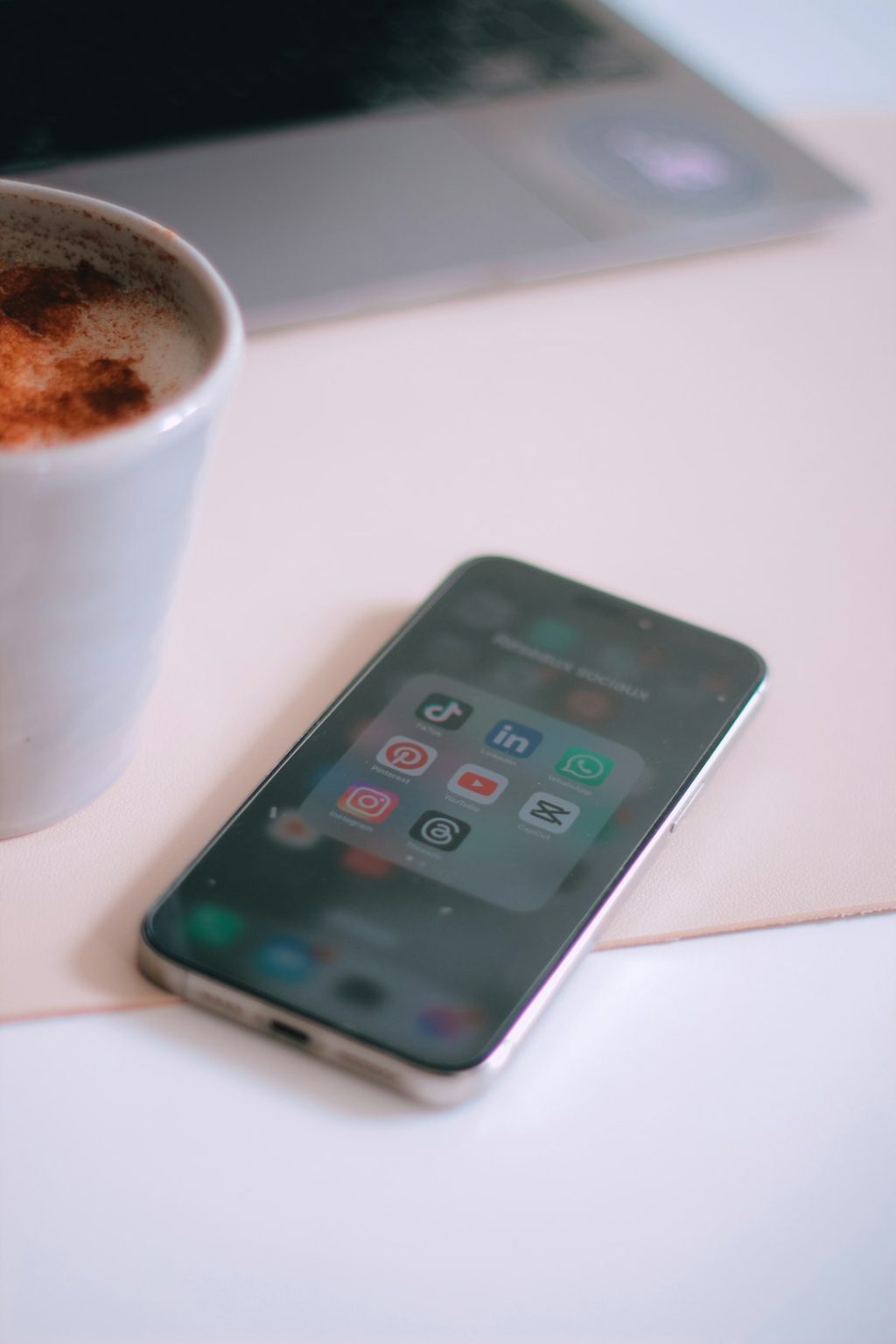 a cup of coffee next to a cell phone capcut speed curve, iphone timeline, smooth slow motion