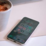 a cup of coffee next to a cell phone capcut speed curve, iphone timeline, smooth slow motion