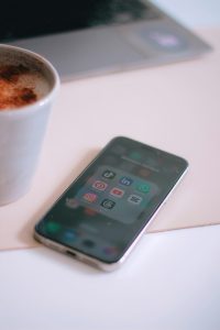 a cup of coffee next to a cell phone capcut speed curve, iphone timeline, smooth slow motion