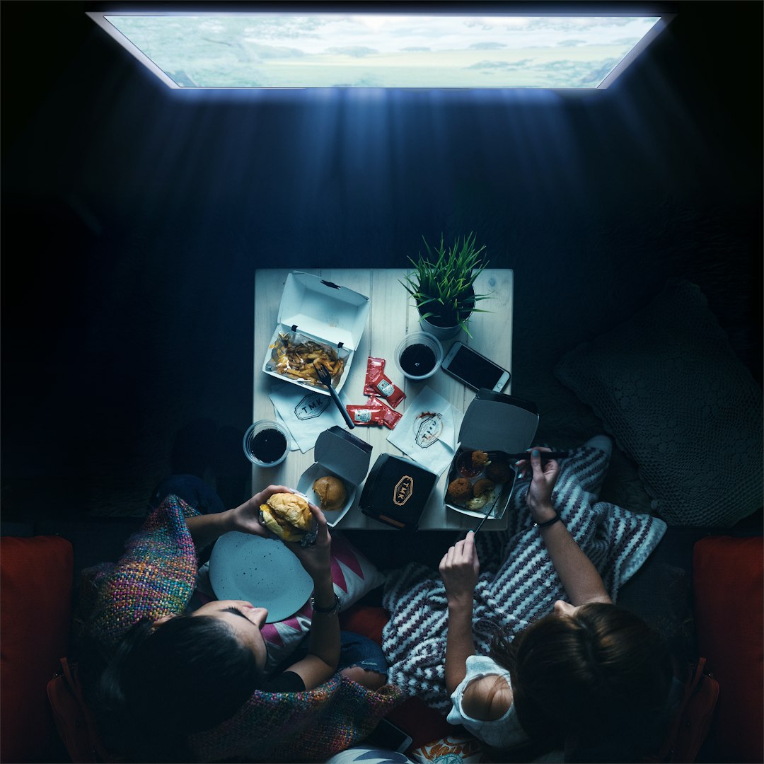 woman in black and white stripe shirt sitting on couch family movie night, popcorn, streaming service, sofa
