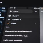 Smartphone screen displaying chatgpt interface on keyboard person typing on laptop, ai interface screen, prompt example text