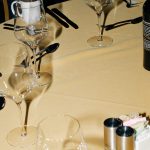 Table setting with wine glasses and cutlery small prosecco bottles, mini sparkling wine, italian prosecco glasses