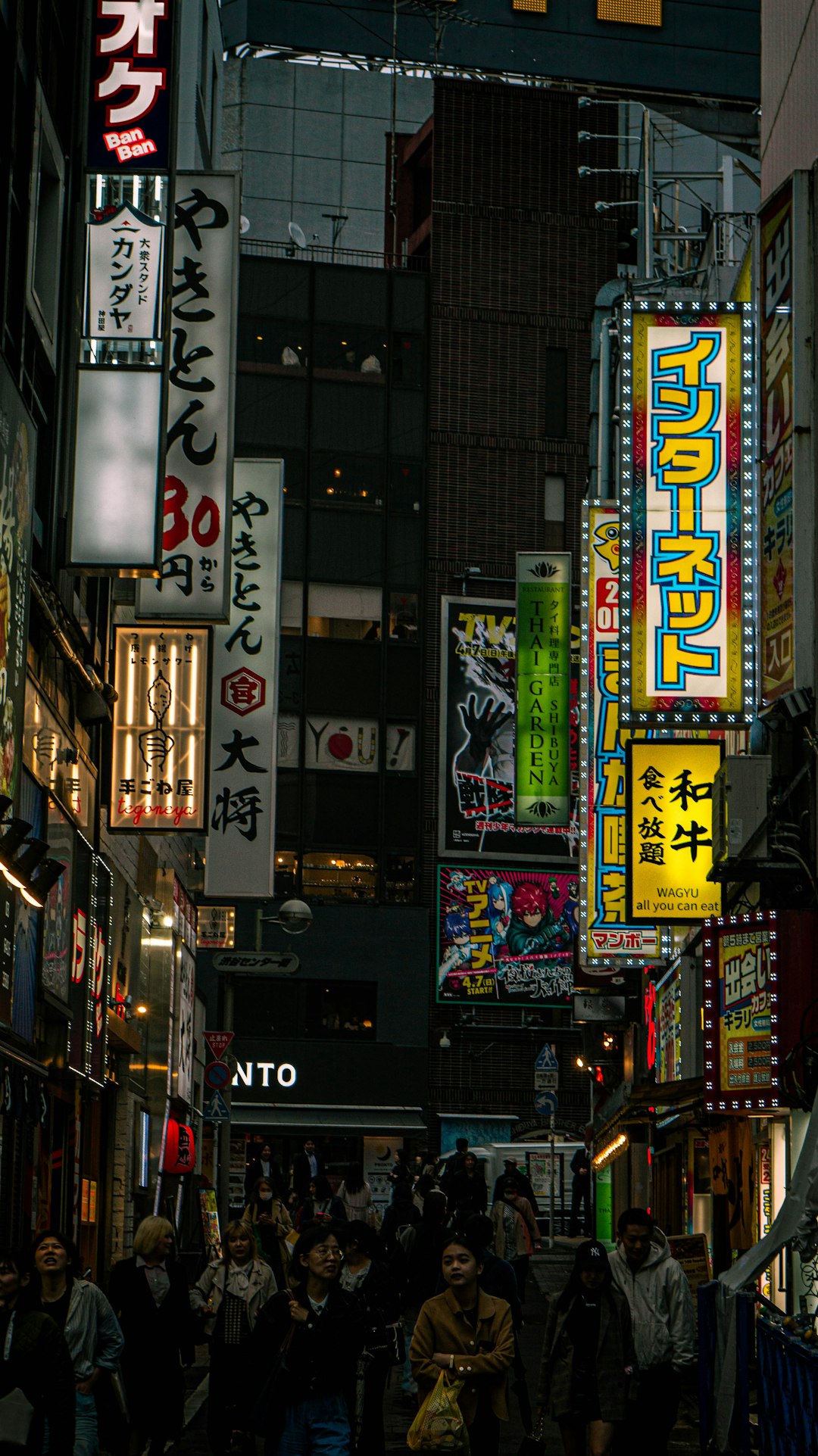 A city street filled with lots of neon signs busy tokyo street, traveler using smartphone, neon signs city