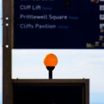 A street sign with an orange ball on top of it windows update settings screen, driver update notification, gaming setup desk