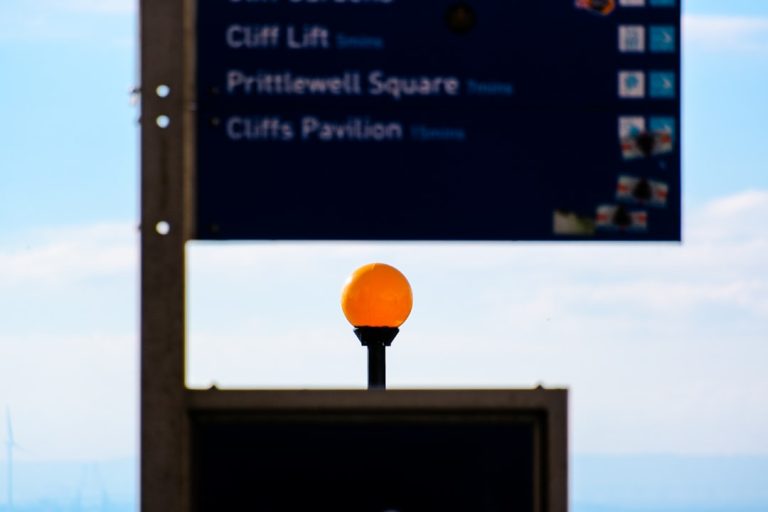 A street sign with an orange ball on top of it windows update settings screen, driver update notification, gaming setup desk