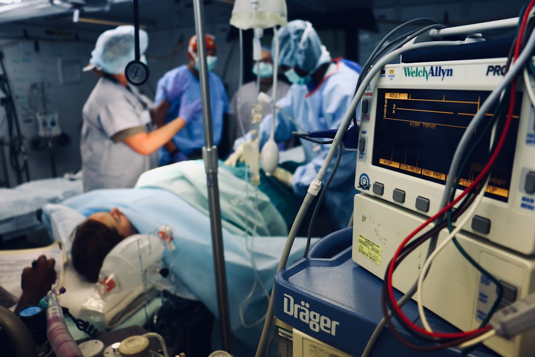 group of people doing a surgery on a person inside the operating room hospital finance team, revenue cycle software, healthcare analytics
