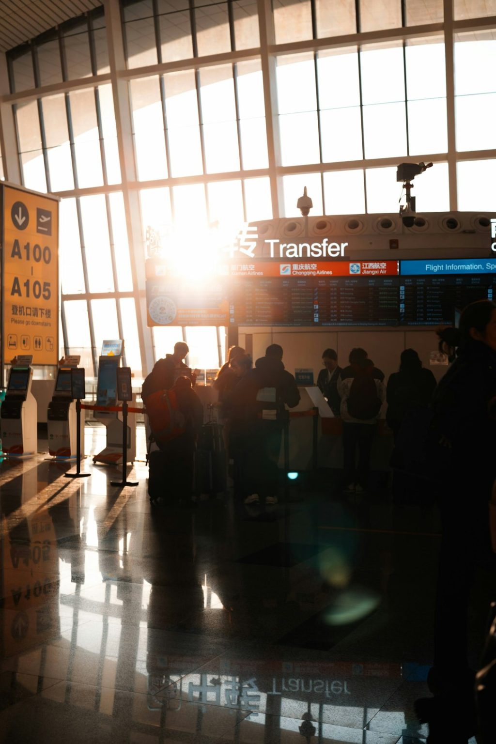 People in airport terminal with sun flare traveler swapping sim card, smartphone close up, airport setting