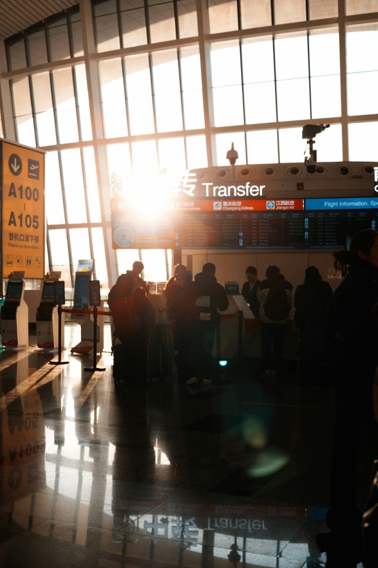 People in airport terminal with sun flare traveler swapping sim card, smartphone close up, airport setting