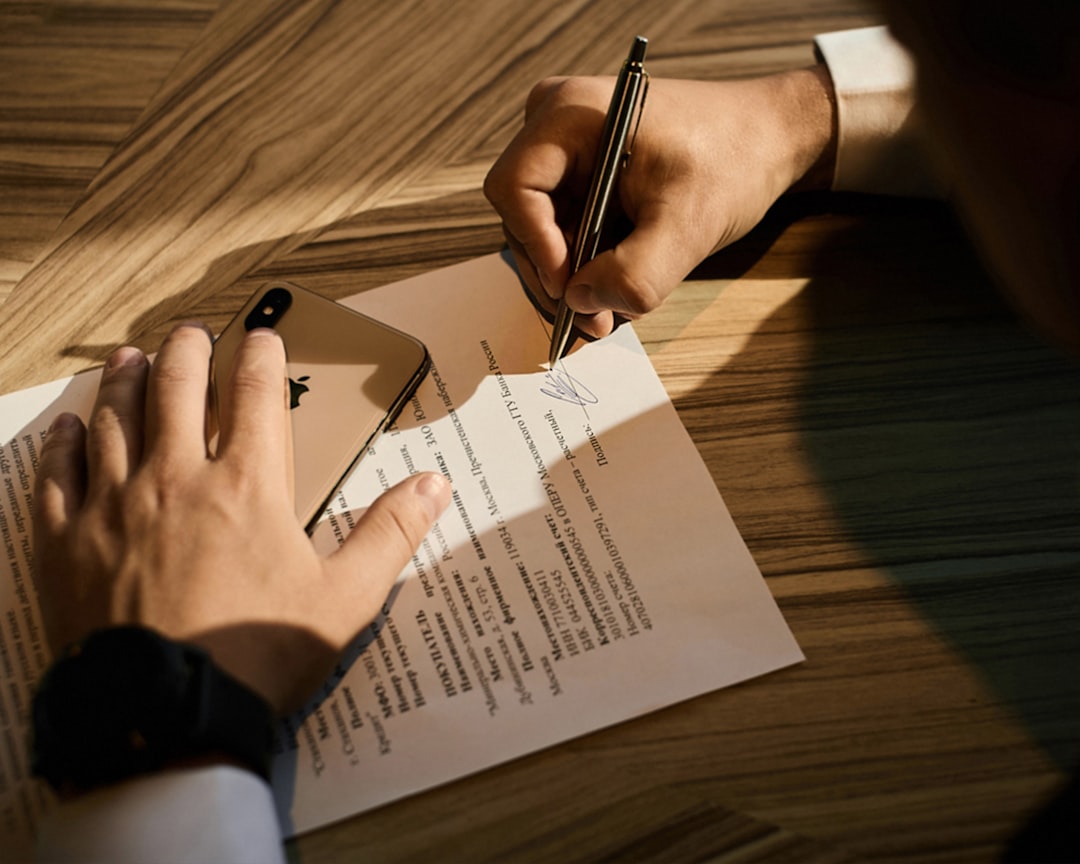 person writing on white paper lawyer signing digital document, secure online contract, legal technology concept