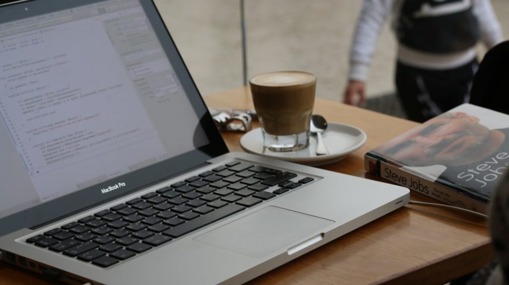 macbook pro on brown wooden table sales team laptop, prospect list interface, email automation workflow