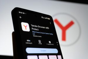 Smartphone displaying yandex browser app information yandex image search results, face recognition example, similar photo matches