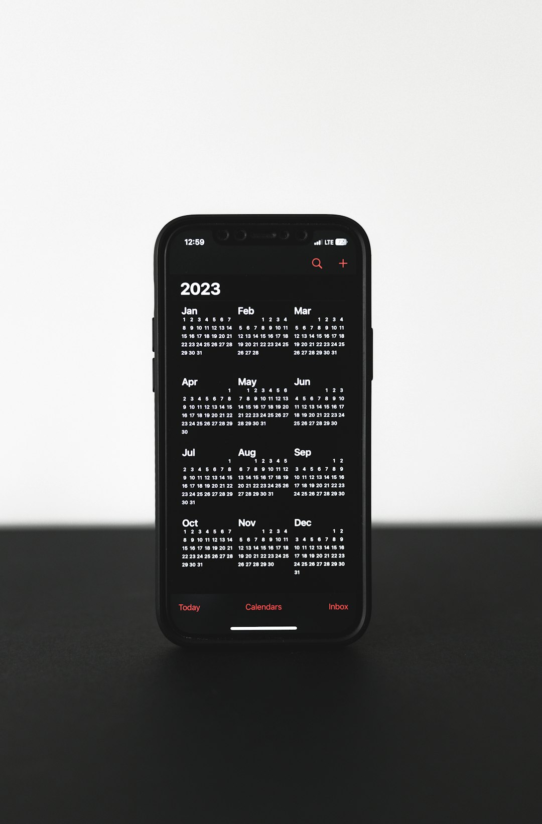 a black cell phone modern scheduling app on smartphone, shared calendar overlay, minimal design