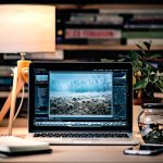 MacBook Pro on brown wooden table inside room photo editing workspace, background removal before and after, image editing software interface