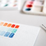 white and orange box on gray surface branding workspace, logo design process, color palette samples