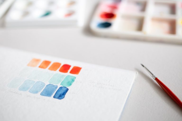 white and orange box on gray surface branding workspace, logo design process, color palette samples