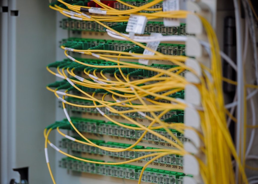 Yellow and green cables are neatly connected. server room, data center, high performance hosting