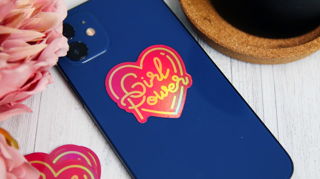a person holding a heart shaped object die cut stickers, laptop decals, marketing giveaway