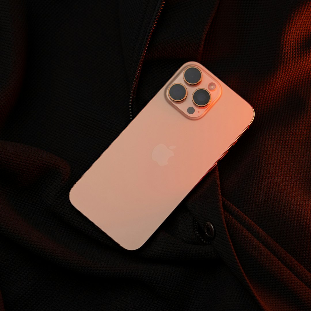A white iPhone case sitting on top of a black jacket iphone 16 plus, large display, performance testing