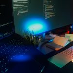 Computer screens displaying code with neon lighting. website builder interface, drag and drop editor, wordpress dashboard, web design workspace