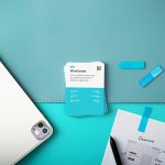 a laptop computer sitting on top of a desk business card template on screen, modern office desk, graphic design interface