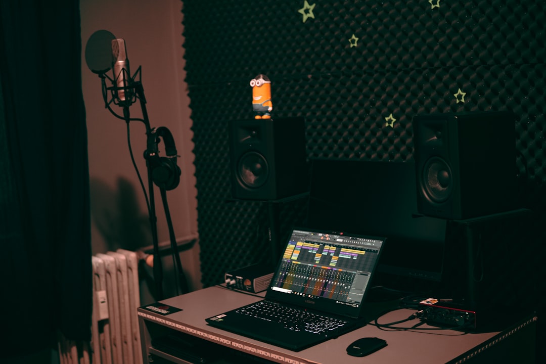 a laptop computer sitting on top of a desk fl studio piano roll, colored notes, music production software