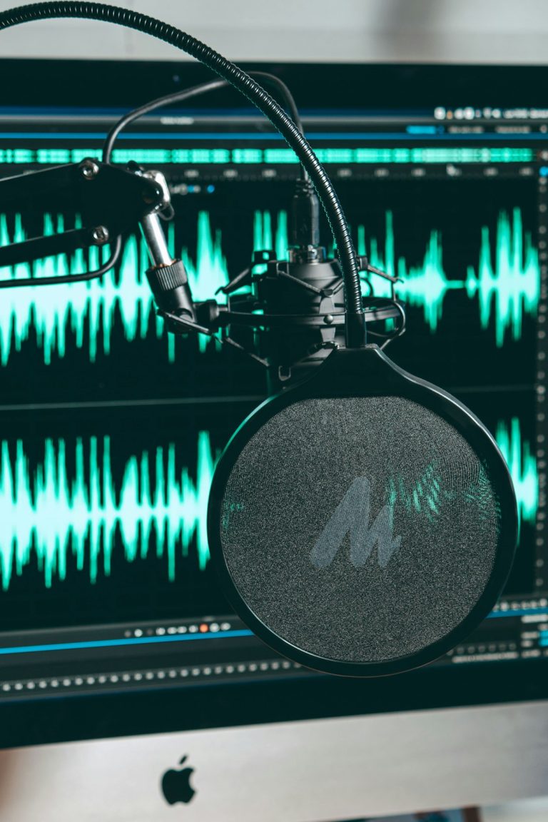 a record player with a record audio waveform, studio microphone, voice editing software