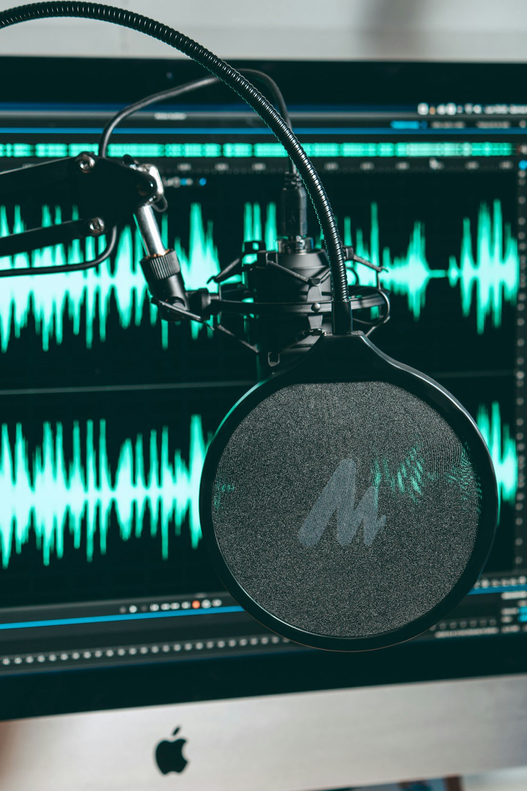 a record player with a record audio waveform, studio microphone, voice editing software