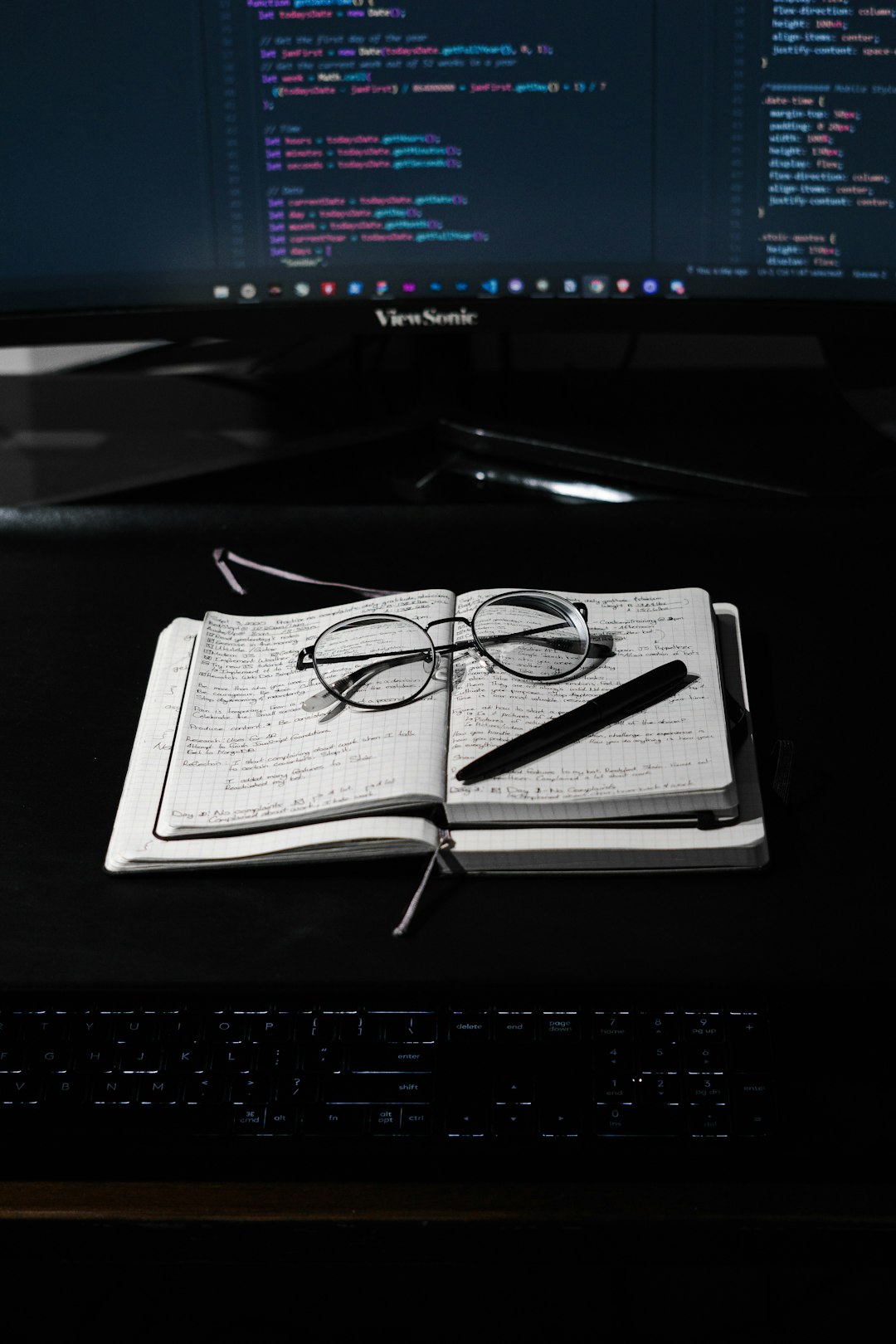 black framed eyeglasses on white paper note taking application interface, markdown editor screen, encrypted notes concept