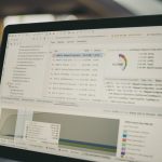 Laptop screen displaying code and data charts. affiliate dashboard analytics screen laptop