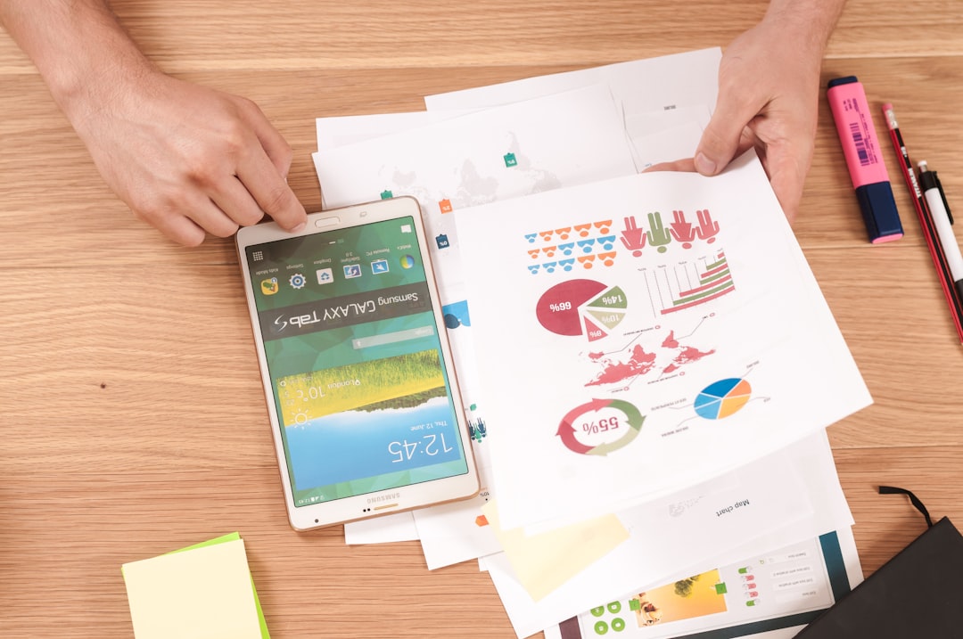 person holding white Samsung Galaxy Tab mobile app planning, revenue model, product strategy