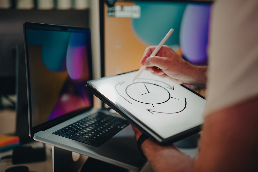A person is writing on a tablet with a pen designer sketching logo on tablet creative process office