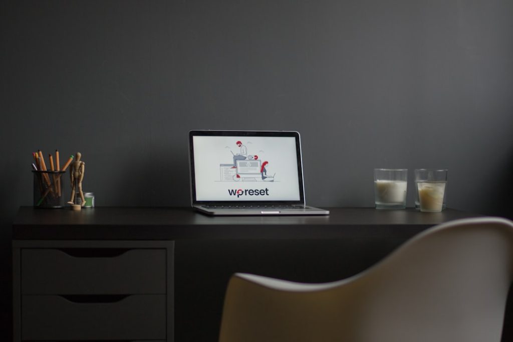 macbook air on black wooden desk modern workspace laptop logo design screen minimal desk