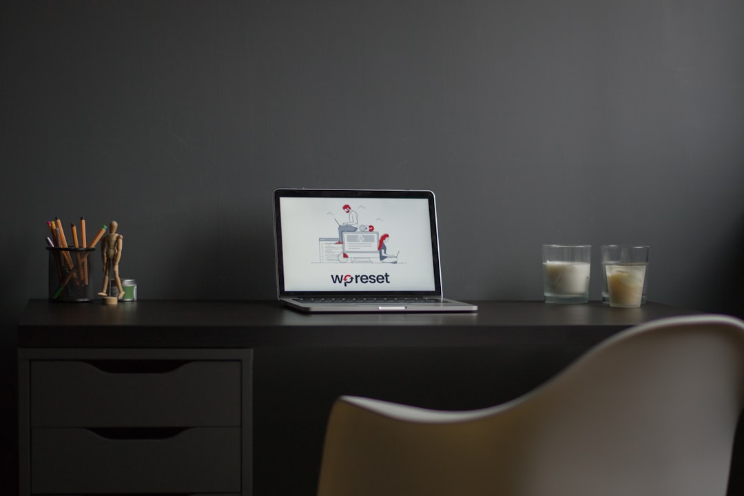 macbook air on black wooden desk modern workspace laptop logo design screen minimal desk