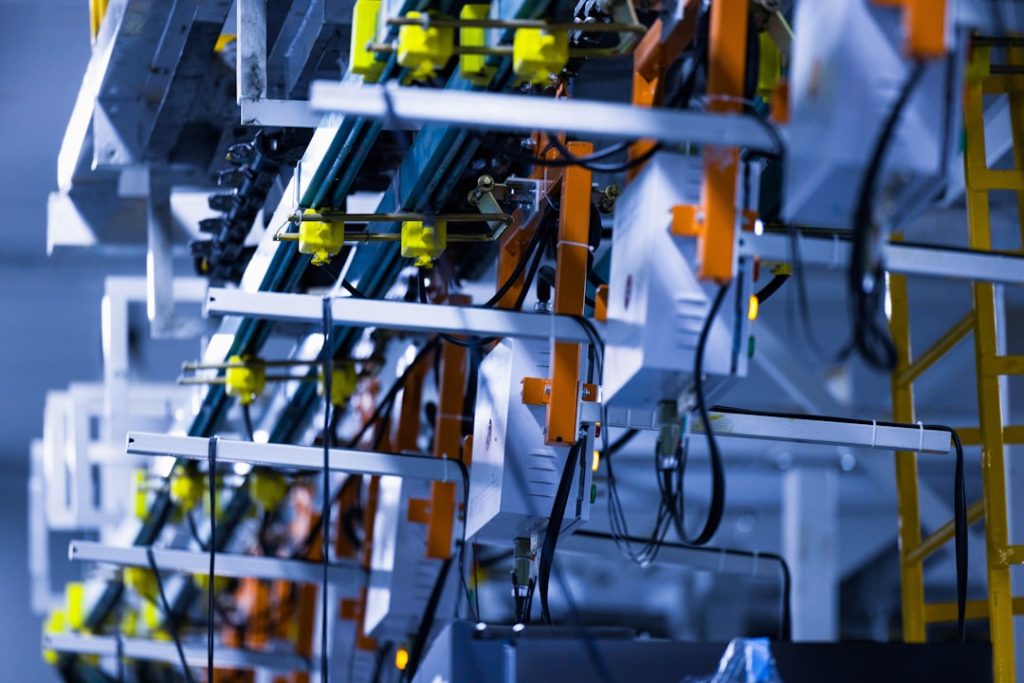 a bunch of wires that are on a rack robotic sorting system, warehouse conveyor robots, package sorting automation