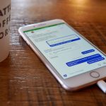 a cell phone on a table customer support chat, mobile app interface, user engagement analytics