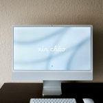 a desktop computer sitting on top of a wooden desk cloud storage dashboard, file sharing screen, laptop and smartphone syncing