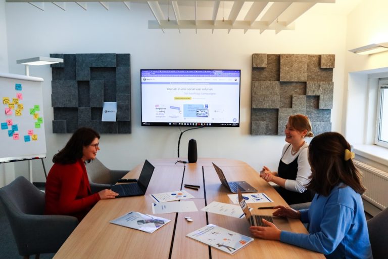 a group of people sitting around a conference table project management dashboard, creative team collaboration, task approval workflow