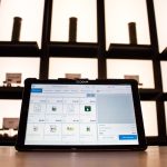 a laptop computer sitting on top of a wooden table cloud storage dashboard, file sharing screen, laptop and smartphone syncing