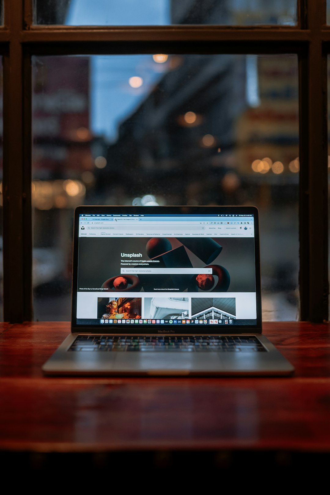a laptop computer sitting on top of a wooden table wifi router on hotel desk, laptop streaming, smartphone connected