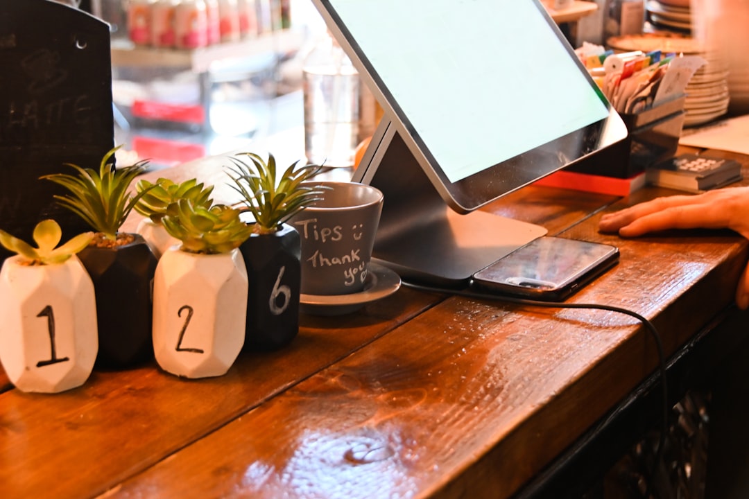 a laptop on a table laptop with vpn interface open, coffee shop setting, public wifi concept