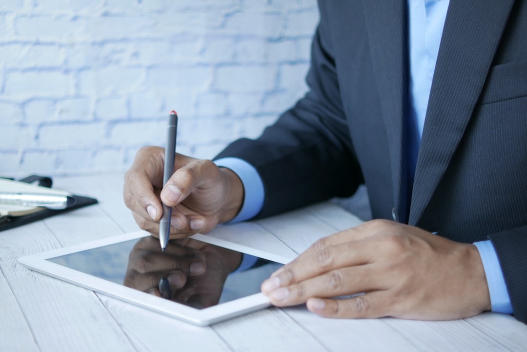 a man in a suit writing on a tablet lawyer signing digital document, secure online contract, legal technology concept