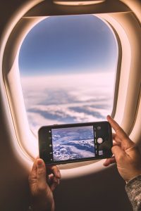 a person holding a phone smartphone flight booking app, price prediction chart, travel planning screen