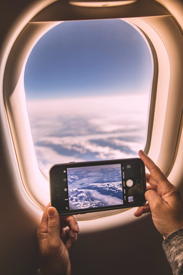 a person holding a phone smartphone flight booking app, price prediction chart, travel planning screen