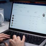 a person typing on a laptop computer on a desk help desk dashboard, ai chatbot, support analytics