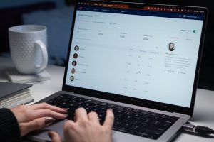a person typing on a laptop computer on a desk help desk dashboard, ai chatbot, support analytics