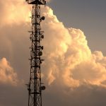 A tall tower with a lot of antennas on top of it cloud load balancing, network traffic distribution, microservices communication, server nodes