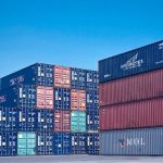 architectural photography of cargo containers stack global ecommerce map shipping routes warehouse logistics