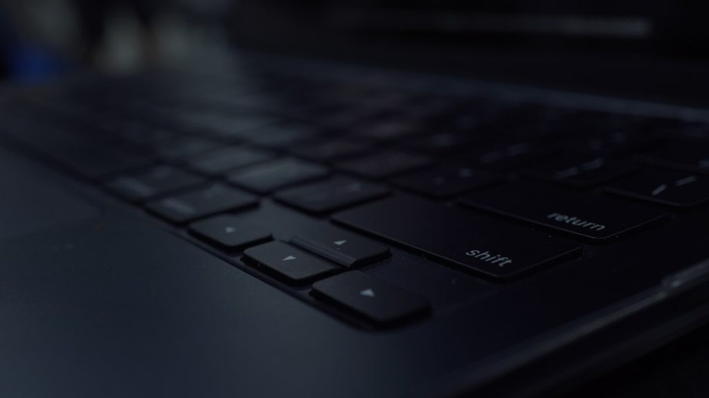 Close-up of a dark computer keyboard developer workspace modern laptop dark mode code editor