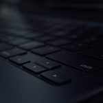 Close-up of a dark computer keyboard developer workspace modern laptop dark mode code editor