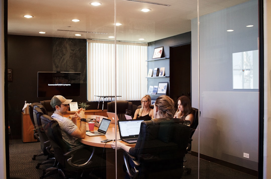 people sitting near table with laptop computer business meeting, professional services, client trust